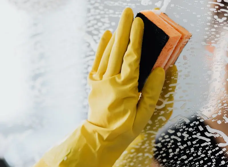 Wiping a glass door with a cloth