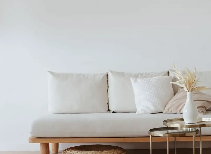 A tidy living room corner with a sofa and side table