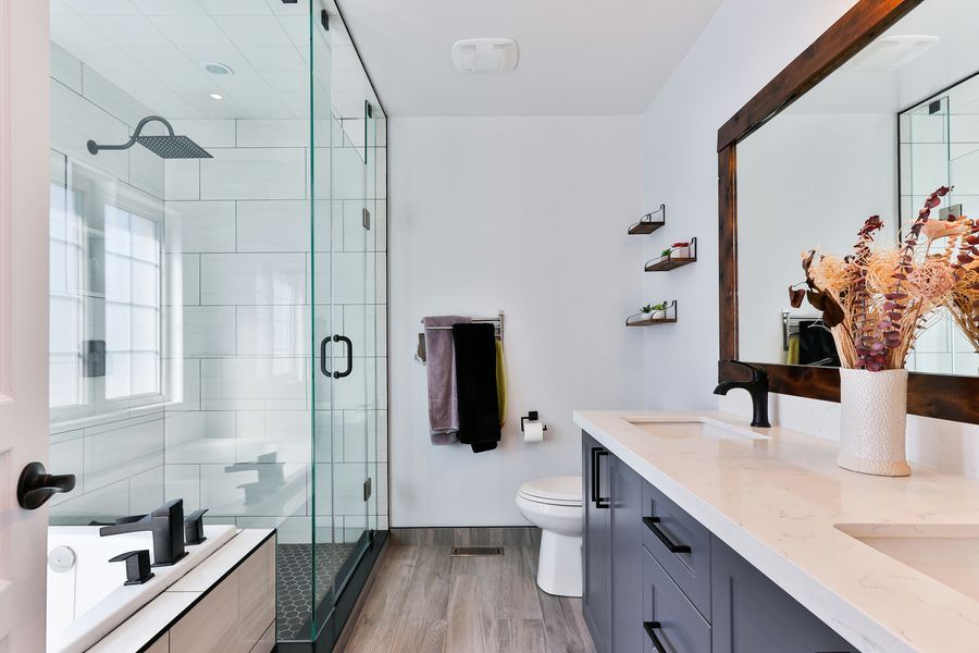 A spotless bathroom with gleaming glass and counters